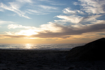 Fototapeta premium Golden sunset over the ocean taken from Clifton Fourth Beach, Cape Town, South Africa.