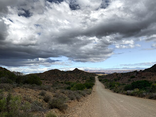 Driving on a mountain pass on a moody day. Road trip, adventure, isolation concepts.