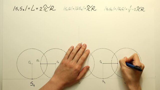 Young mathematician hands marks a point "E3" on a circles for a cycloid construction. Date of shooting day 26 December 2021 year, MSK time. This video was filmed in Russia.