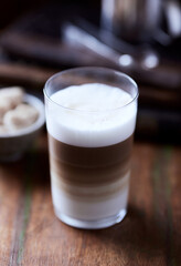 Coffee with milk on wooden background. Soft focus. Close up.