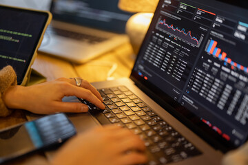 Woman working on some programming dashboard on laptop, close-up on hands and keyboard. Programmer,...