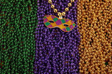 Mardi Gras Mask and colorful Mardi Gras Beads Background