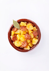 Potatoes stew with chorizo, patatas a la riojana, on white background