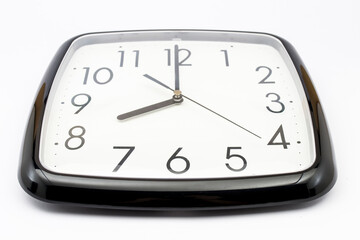 Black classic clock on isolated white background.