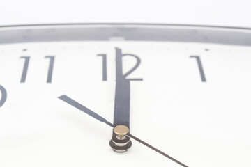 Black classic clock on isolated white background.