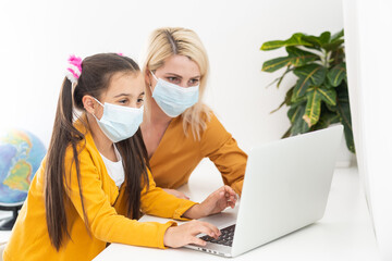 Mother working from home with kids. Quarantine and closed school during coronavirus outbreak....