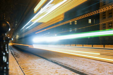 Tram blurred by motion, abstract photo, public transportation in Poznan, Poland. Night shot.