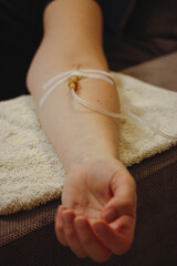 Woman's hand with catheter for dropper, butterfly needle used to draw blood from a vein or to...