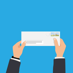 Man's hand holding envelope