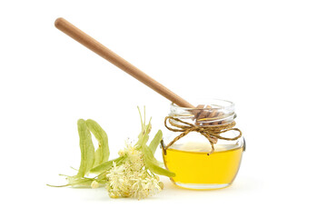 Honey jar with linden blossom and wooden dipper isolated on white