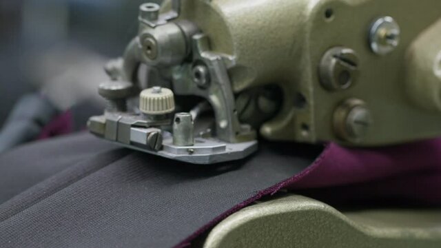 the process of cutting fabric with an industrial machine close-up