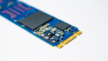 SSD hard drive NVMe version for slot M.2 laid on white background and narrow focus at pinout