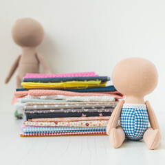 Close-up view on the creative process of sewing doll, details of doll cloth sewing machine on the table background. High quality photo