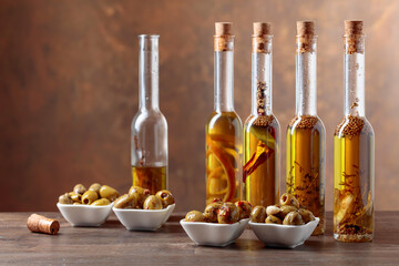 Spiced green olives and bottles with olive oil .