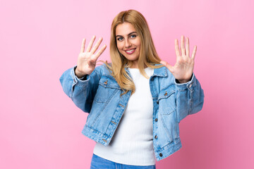 Young Uruguayan blonde woman over isolated pink background counting nine with fingers