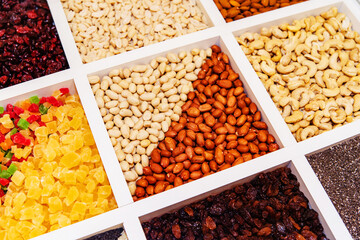 Nuts and marmalade of various types on the counter in the store. Trade in ingredients for confectionery. Selective focus
