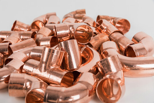 Group of fittings on a white background. Copper fittings for pipe connections. Technical basis for heating companies.