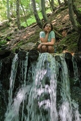 Fototapeta na wymiar girl near the waterfall