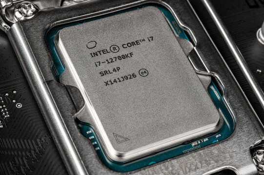 Moscow, Russia - January 12, 2022: Latest Intel i7 12700kf processor chip in socket on motherboard. Intel is one of the worlds largest semiconductor chip makers. close-up