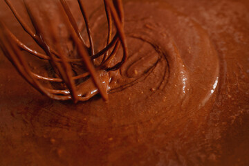 cooking of chocolate cream and hand mixer close-up