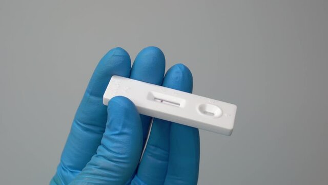 Closeup shot of a hand holding a negative antigen test.Stealth omicron BA.2 variant may be somewhat harder to detect.