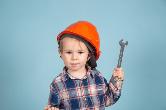 Child is holding wrenches. Construction and repair concept.