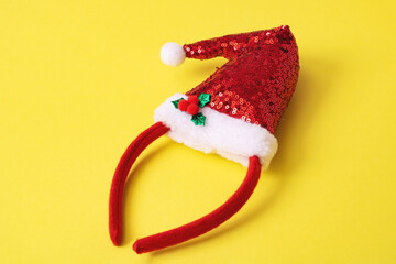 Red Santa Claus hat on yellow background
