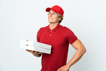 pizza delivery man over isolated white background posing with arms at hip and smiling