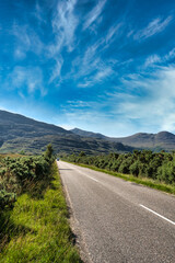 Fototapeta na wymiar A van driving through a highway in Torridon. Highlands, Scotland.
