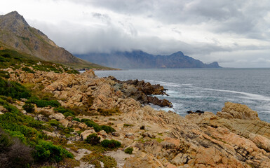 Fototapeta na wymiar Beautiful coastal view of False bay and the Hottentots Holland mountains along the Clarence drive between Gordons Bay and Rooiels in the western cape, near Capetown in South Africa