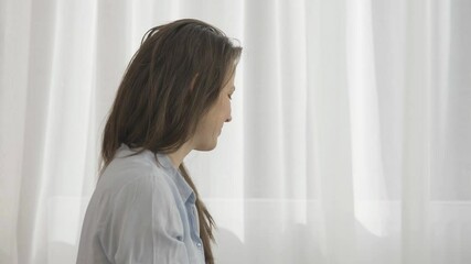 Young lady enjoys new mother role sorting newborn baby clothes