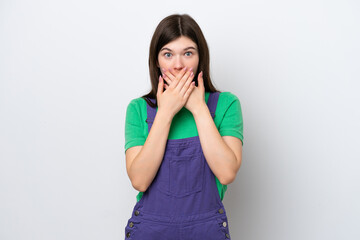 Young Russian woman isolated on blue background covering mouth with hands