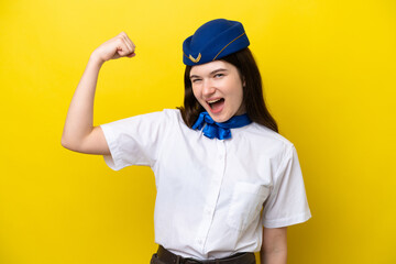 Airplane stewardess Russian woman isolated on yellow background doing strong gesture