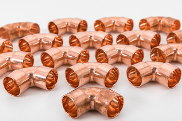 Group of fittings on a white background. Copper fittings for pipe connections. Technical basis for...