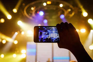 People at the concert. Using a smartphone