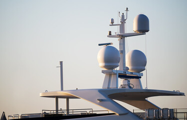 Closeup view of navigation radar system antennas yacht on blue sky background