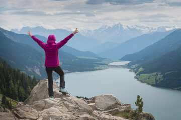 woman rising arms vantage point lake tyrol