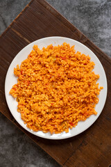 Bulgur pilaf on a dark background. Close-up of Turkish food Bulgur Pilav in a ceramic plate. Top view