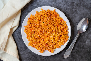Bulgur pilaf on a dark background. Close-up of Turkish food Bulgur Pilav in a ceramic plate. Top view