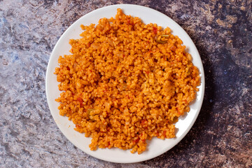 Bulgur pilaf on a dark background. Close-up of Turkish food Bulgur Pilav in a ceramic plate. Top view