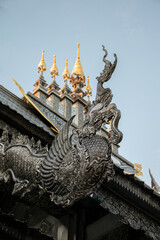 silver statue on the top roof of Thai temple, Wat Sri Suphan
