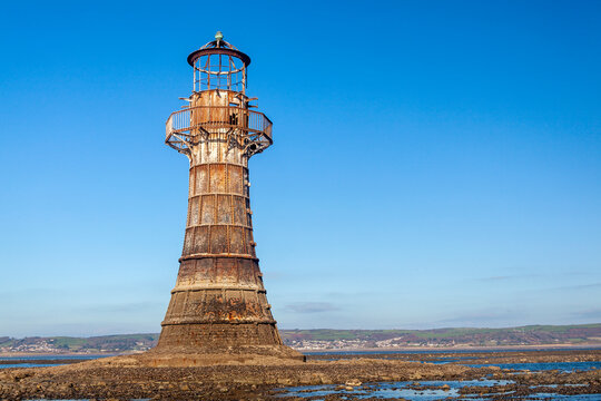 Whitford Lighthouse a cast iron Victorian ruin on the north coast of the Gower Peninsular South Wales UK which is a popular tourist holiday travel destination and landmark attraction, stock photo 