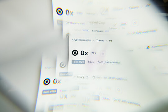 Milan, Italy - January 11, 2022: 0x - ZRX logo on laptop screen seen through an optical prism. Dynamic and unique image form 0x, ZRX coin website. Illustrative editorial.