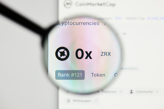 Milan, Italy - January 11, 2022: 0x - ZRX website's hp.  0x, ZRX coin logo visible through a loope. Defi, ntf, cryptocurrency concepts illustrative editorial.