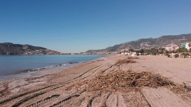 Flying Over Dirty Beach With Tree Debris After Powerful Storm. Garbage On Beach Of Alanya Seashore