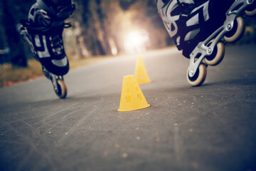 Roller skating slalom around yellow cones