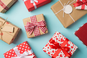 Obraz premium Top view photo of st valentine's day decorations presents gift boxes on isolated pastel blue background