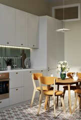modern design, white kitchen, apartment with high ceilings, green splashback, green tiles, dining table, bright dining chairs, balcony in the kitchen