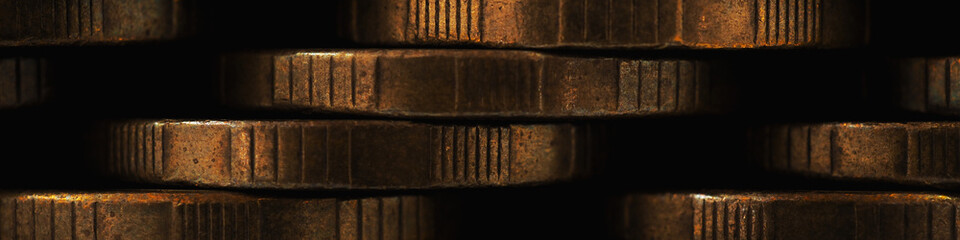 Stacks of coins close-up. Money textured banner. Dark brown business headline made of many coin edges. Russian tens. Economy finance and banking. Macro