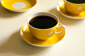 yellow cups with black tea. retro tea-set. vintage mug and plate